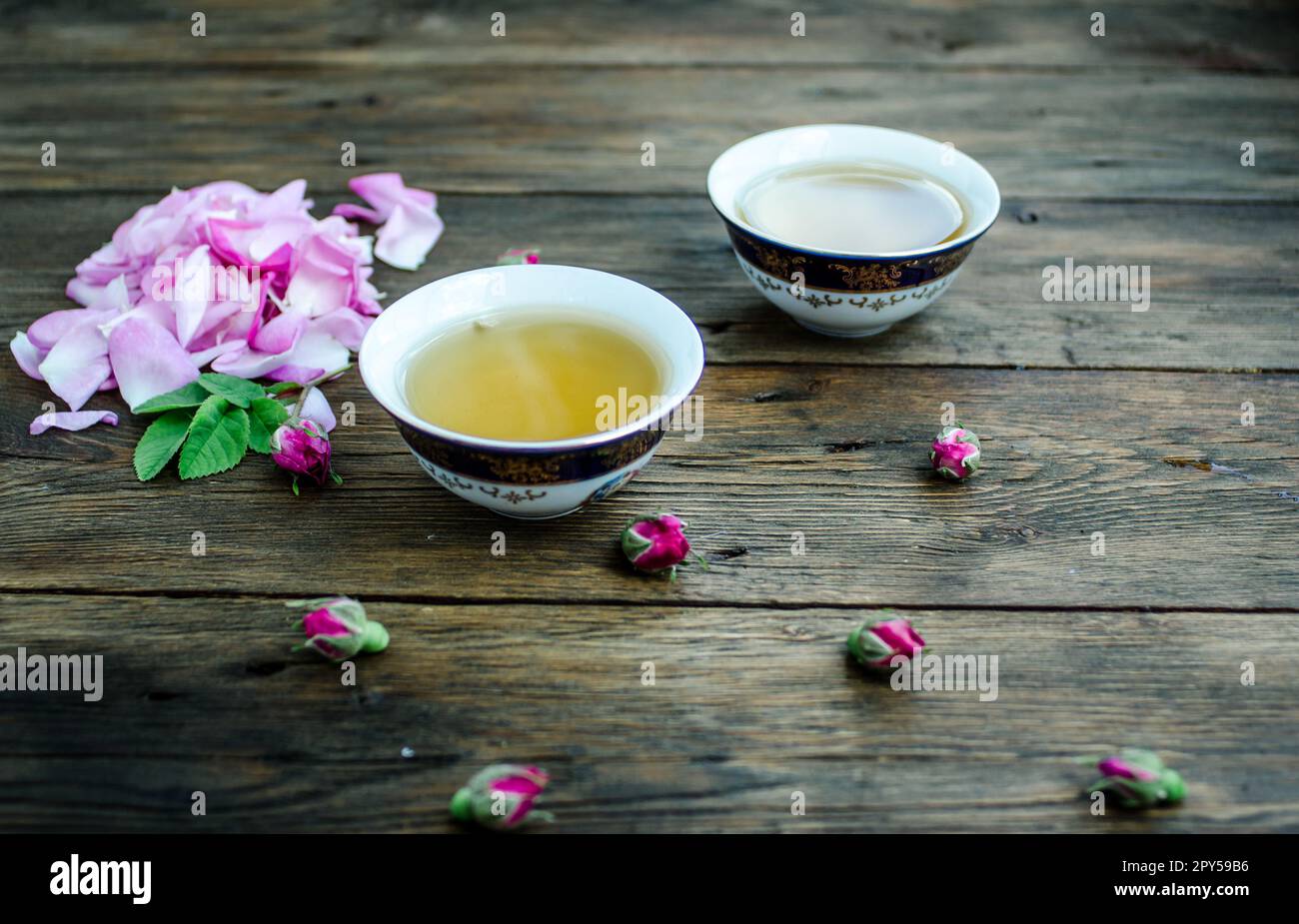 Tasse Tee mit Rose auf weiße Holztisch Stockfoto