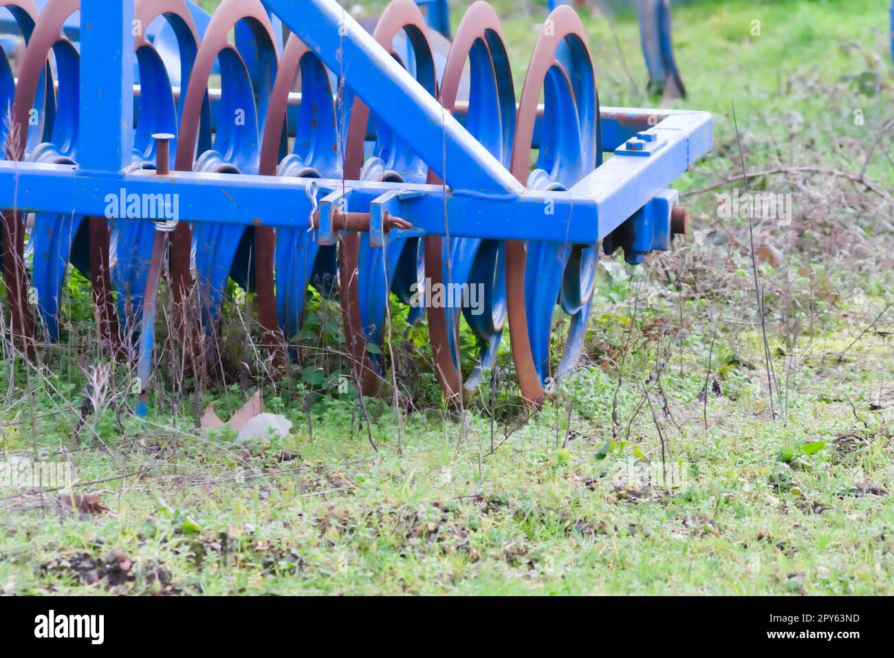 Blaue schwere landwirtschaftliche Geräte wie Pflug mit scharfen ...