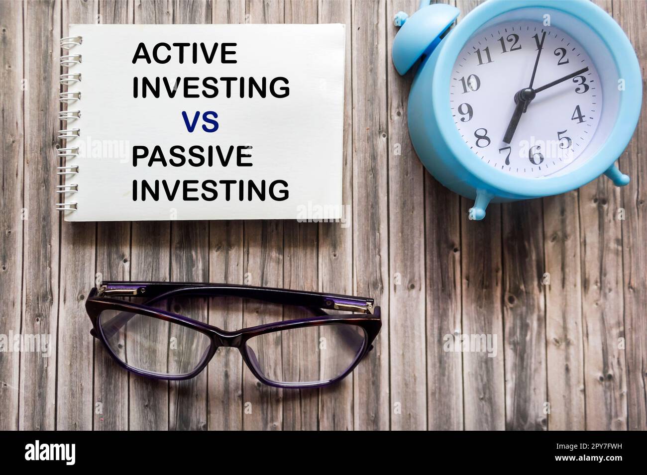 Text zu aktiven und passiven Investitionen – vor- und Nachteile auf Notizblock Stockfoto