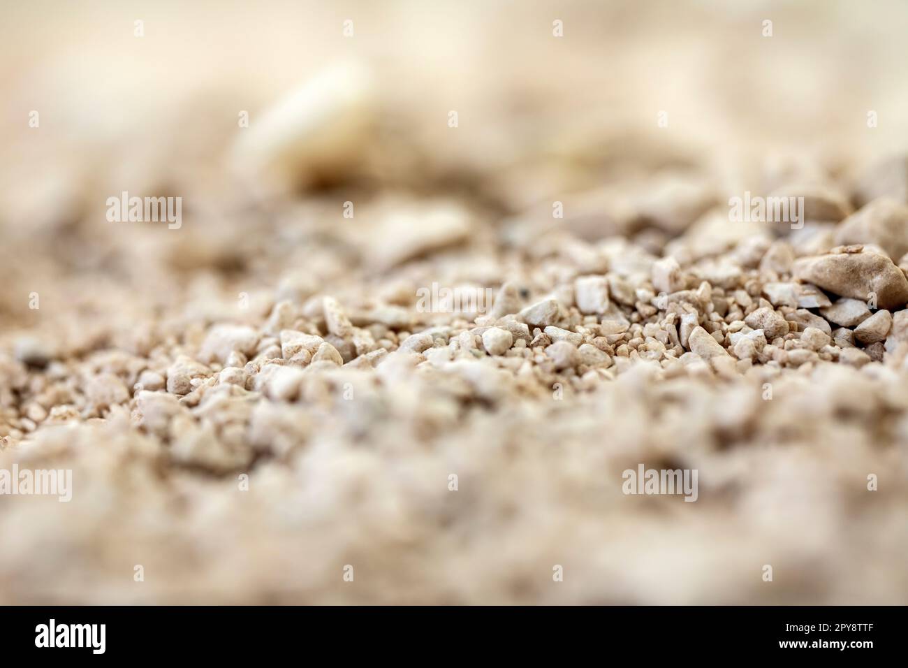Details der Sandsteinstruktur Hintergrund nahtloser Sandselektivfokus. Makro-Nahaufnahme weicher Farben Stockfoto