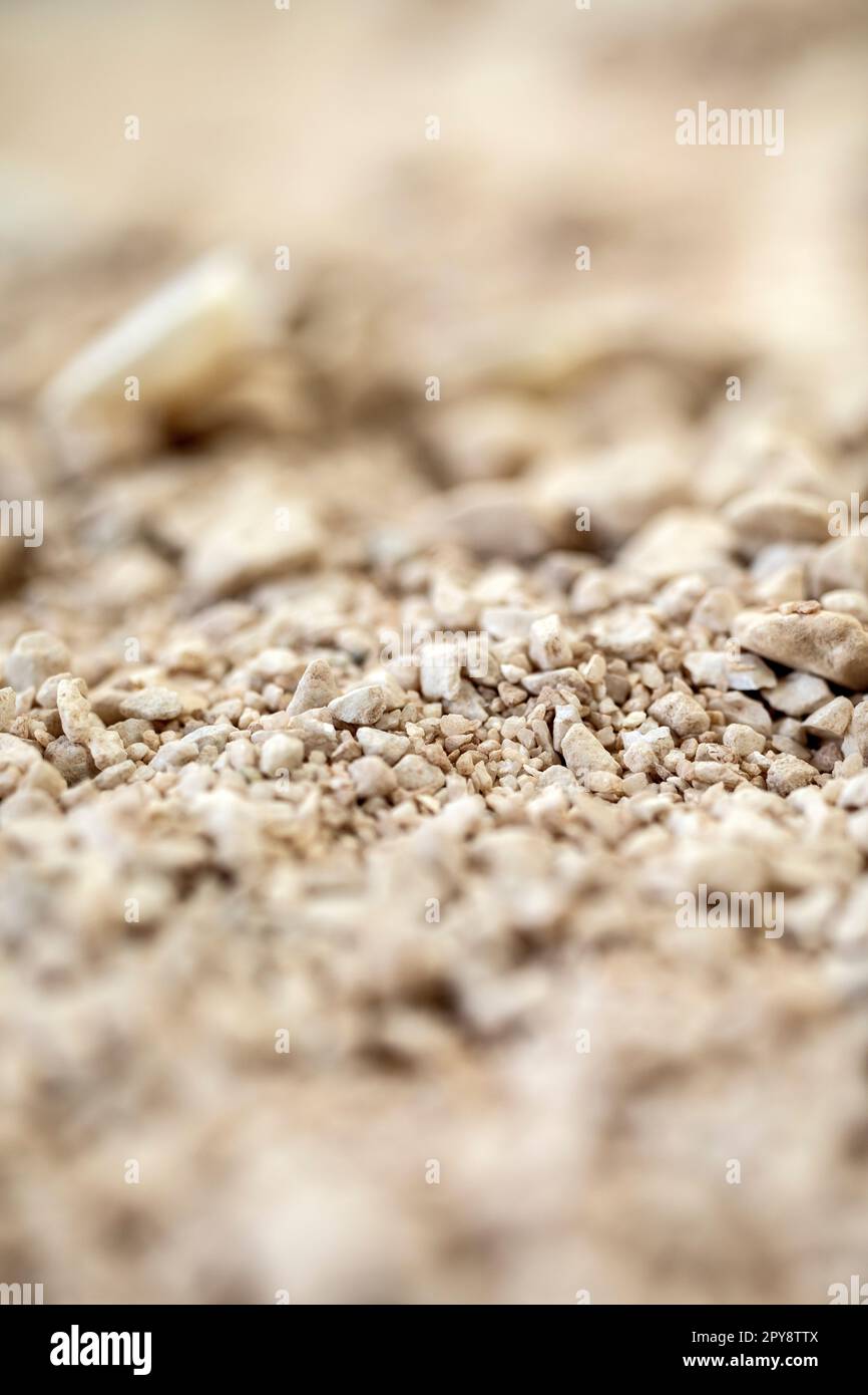 Details der Sandsteinstruktur Hintergrund nahtloser Sandselektivfokus. Makro-Nahaufnahme weicher Farben Stockfoto