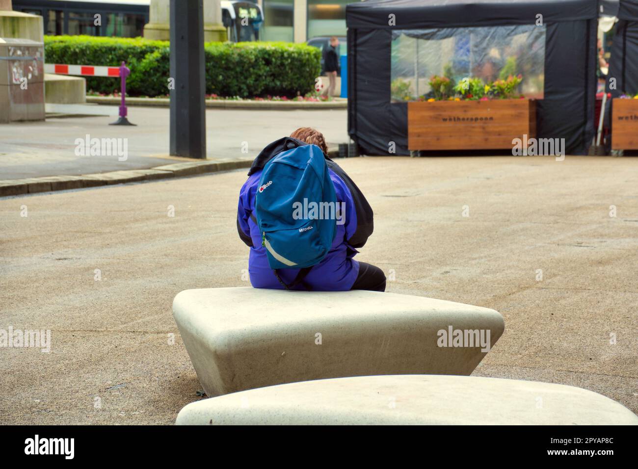 Tourist mit Rucksack sitzt und wartet auf dem george Square Stockfoto