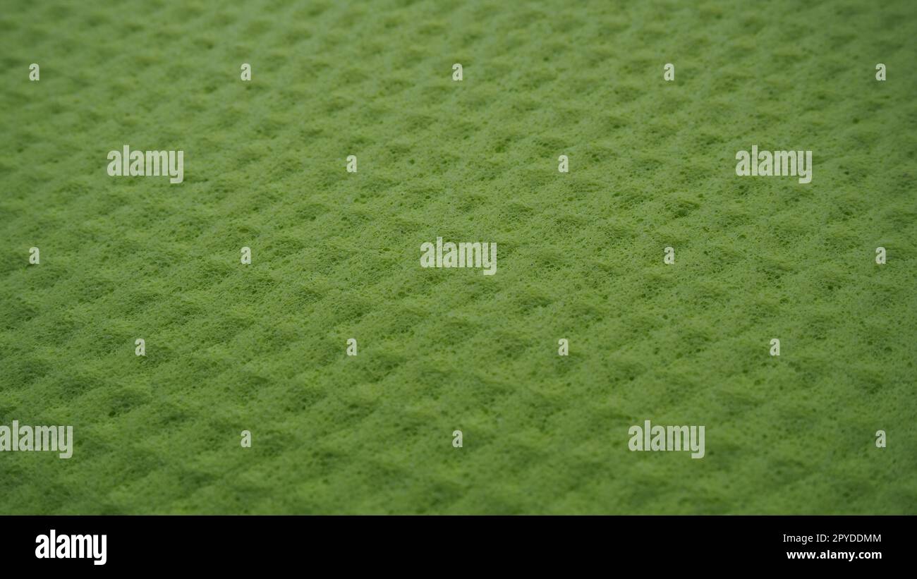 Schaumstofffasern Schwamm Texturmuster Oberfläche Nahaufnahme grün gelber Hintergrund Stockfoto