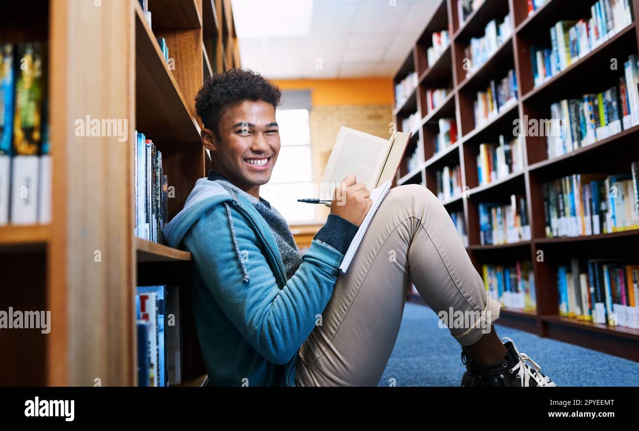 Ich habe einen ruhigen Ort zum Lernen gefunden. Gekürztes Porträt eines Universitätsstudenten, der in der Bibliothek recherchiert. Stockfoto