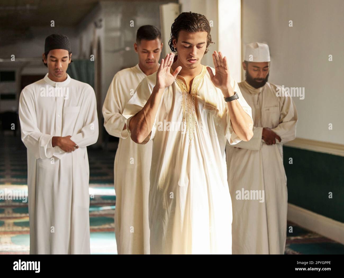 Männer, Moschee und muslimische Gebete an Allah für Religion, ramadan-Karäem und die Verehrung der arabischen Kultur. Eine Gruppe von Menschen betet mit islamischem Imam zu Gott mit heiligem dua, spirituellem Fokus und Frieden in Katar Stockfoto