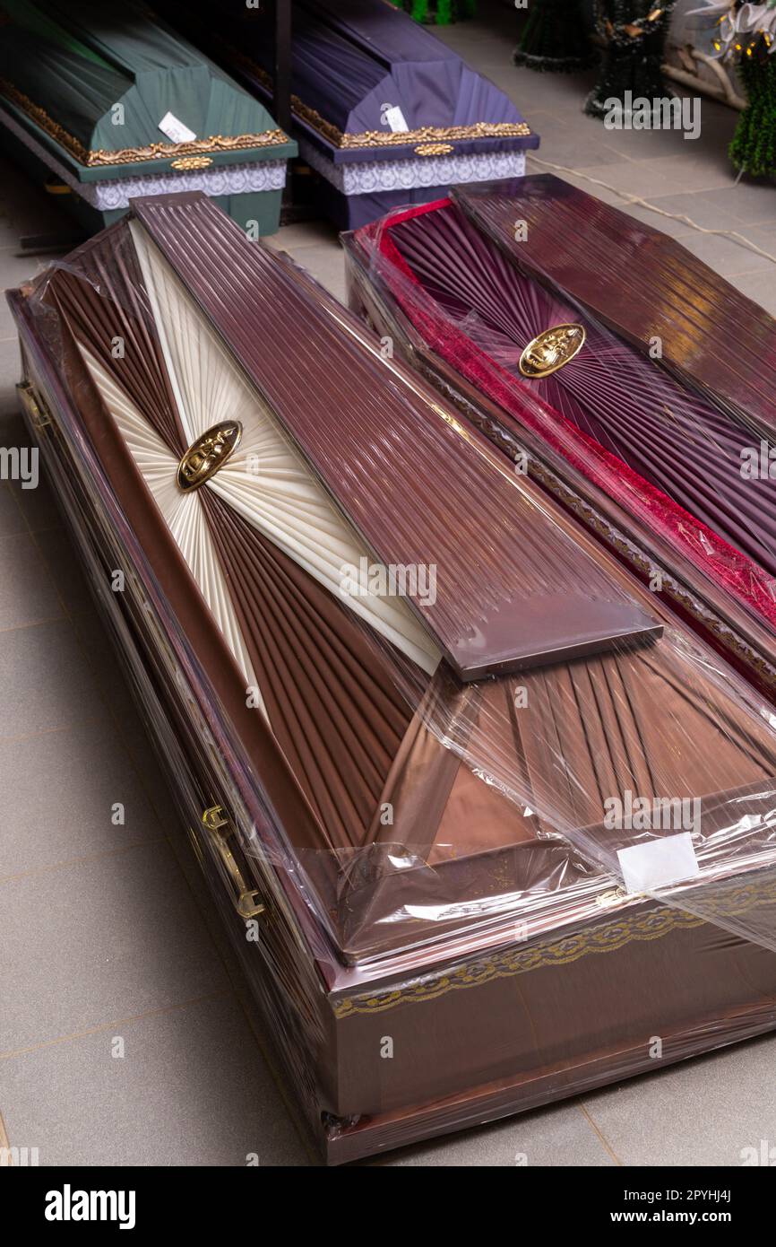 Innenraum des Raumes mit Bestattungszubehör. Geschäft mit Särgen, Beerdigungskränzen und Blumen. Stockfoto