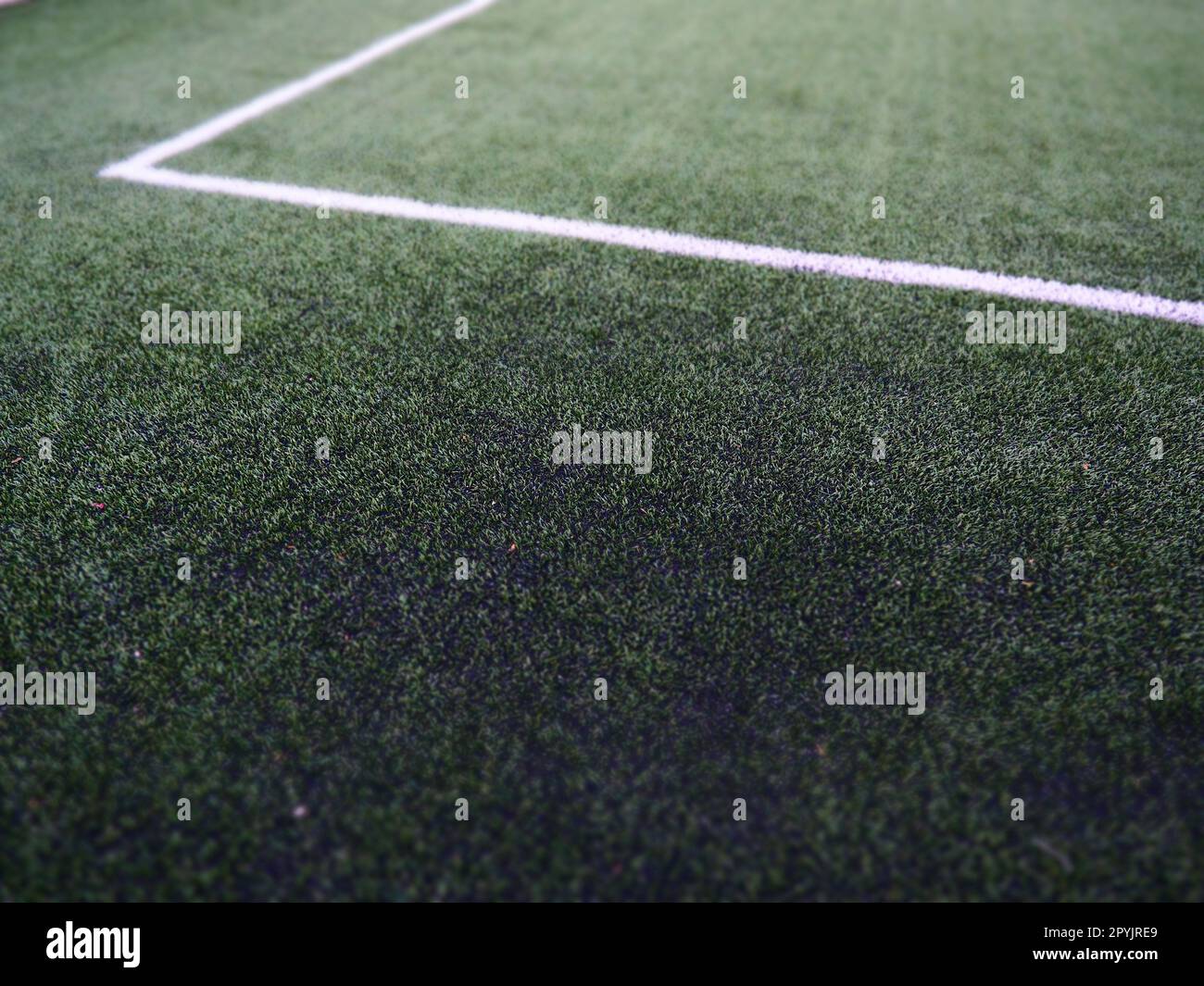 Die Markierung des Fußballfeldes auf dem grünen Gras. Weiße Linien mit einer Breite von maximal 12 cm oder 5 Zoll. Fußballfeld. Stockfoto