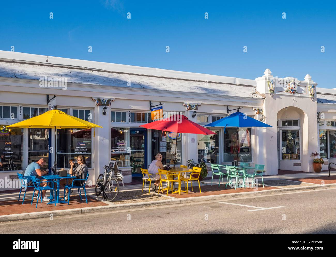 Café im Freien mit farbenfrohen Sonnenschirmen, Tischen und Stühlen auf der Maimi Avenue im Zentrum von Venedig, Florida, USAVenice, Florida, USA Stockfoto