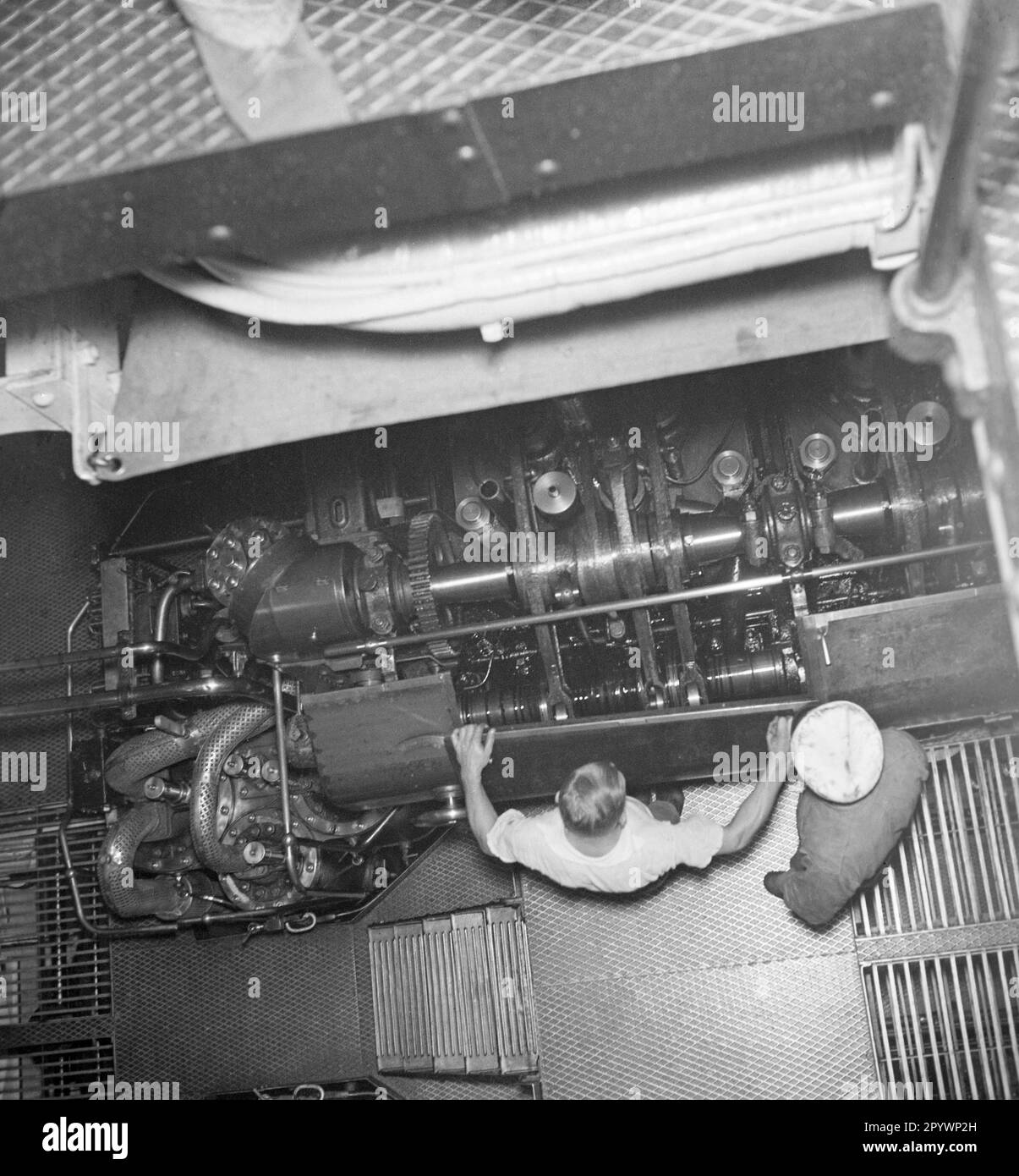 Zwei Mechaniker im Maschinenraum des Passagierschiffs 'Monte Rosa' in den 1930er. Die Ventile des Dieselmotors sind leicht zu erkennen.“ Stockfoto