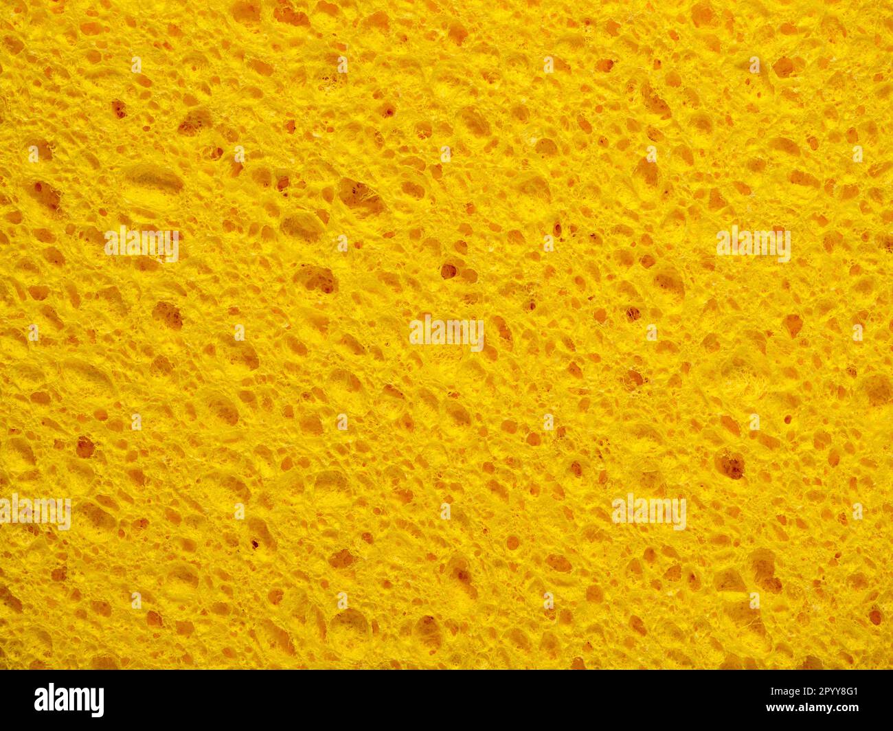 Abstrakter Hintergrund mit detaillierter Textur eines gelben Waschschwamms Stockfoto