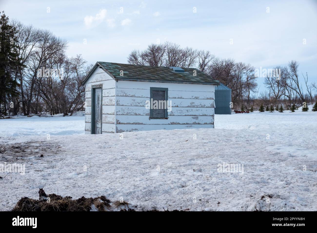 Verfallenes Gebäude auf einem Bauernhof in Nord-dakota im Winter mit blauem Himmel Stockfoto