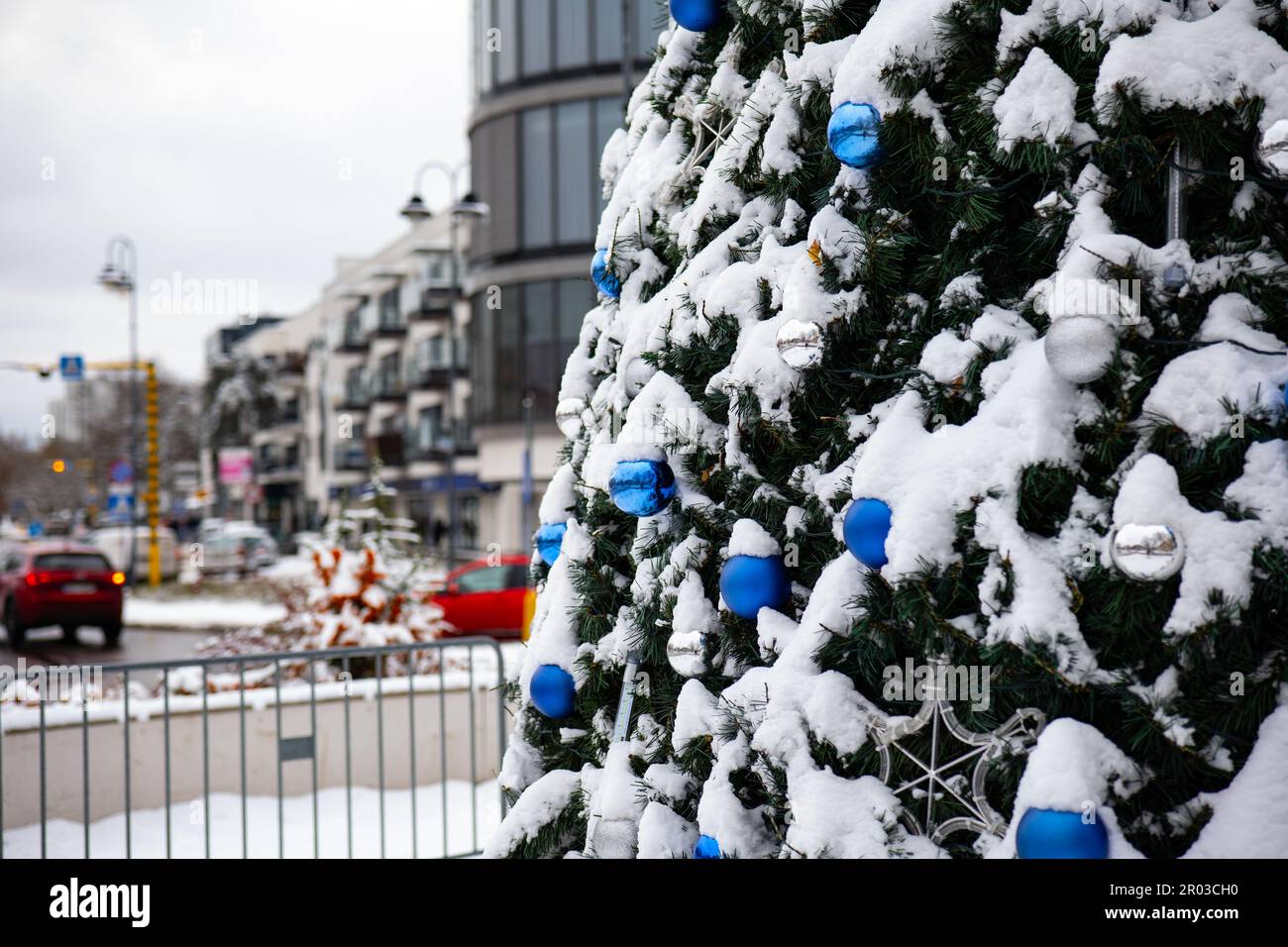 Eine lebhafte festliche Stadt mit dekoriertem Weihnachtsbaum, geschmückt mit bunten Kugeln und Lichtern Stockfoto