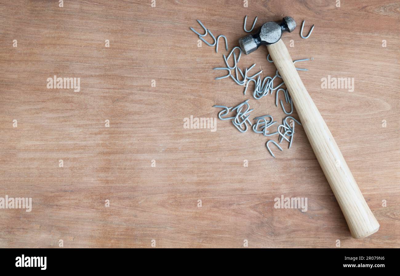 Hammer und Heftklammern auf einer Holzwerkbank. Stockfoto