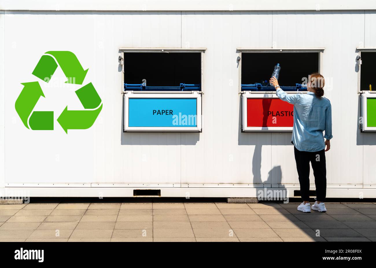 Getrennte Abfallsammelstelle auf der Straße und Person, die Plastikmüll in den Müll wirft. Stockfoto