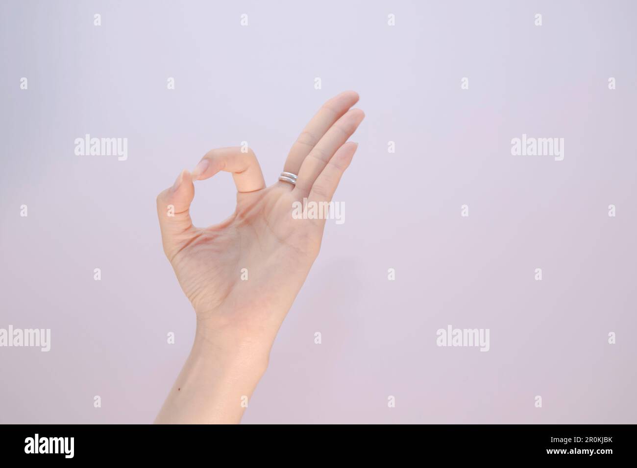 Frau macht Hand ok auf weiß isoliert, Hintergrund Nahaufnahme der Frau Hand Gesten - zeigt Zeichen OK Stockfoto