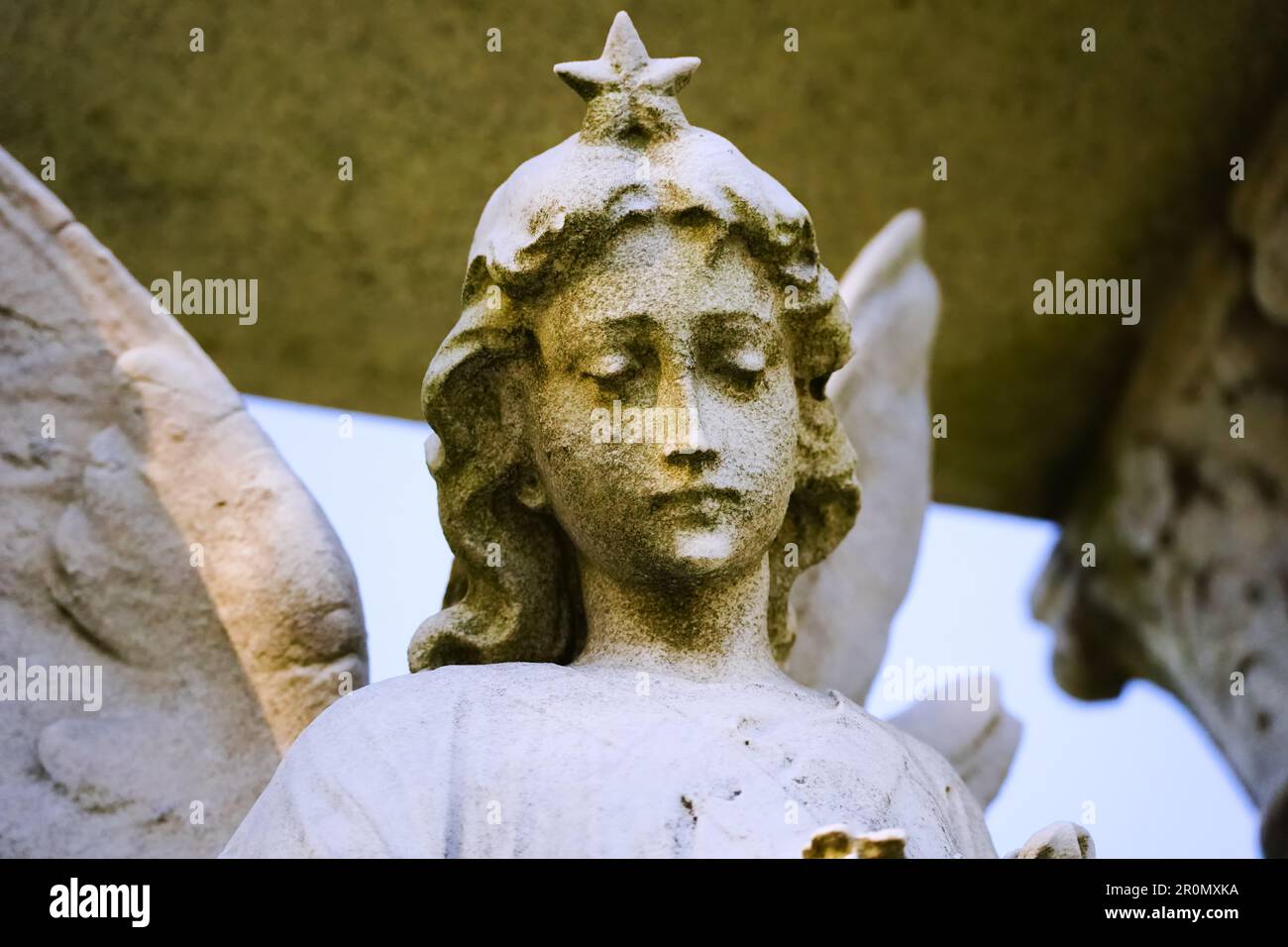 Verwitterte und moosige wunderschöne Engelsstatue im Art déco-Stil der 1920er Jahre mit Sternenhimmel auf dem New Yorker Friedhof Stockfoto