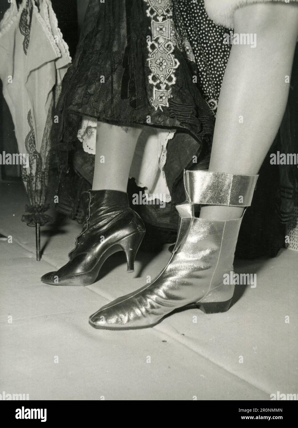 Schuhe Fashion's GAP von 75 Jahren: Vergleich eines viktorianischen Stiefels mit hohen Absätzen und eines Schuhs mit goldenem 1966-Absatz, UK 1966 Stockfoto