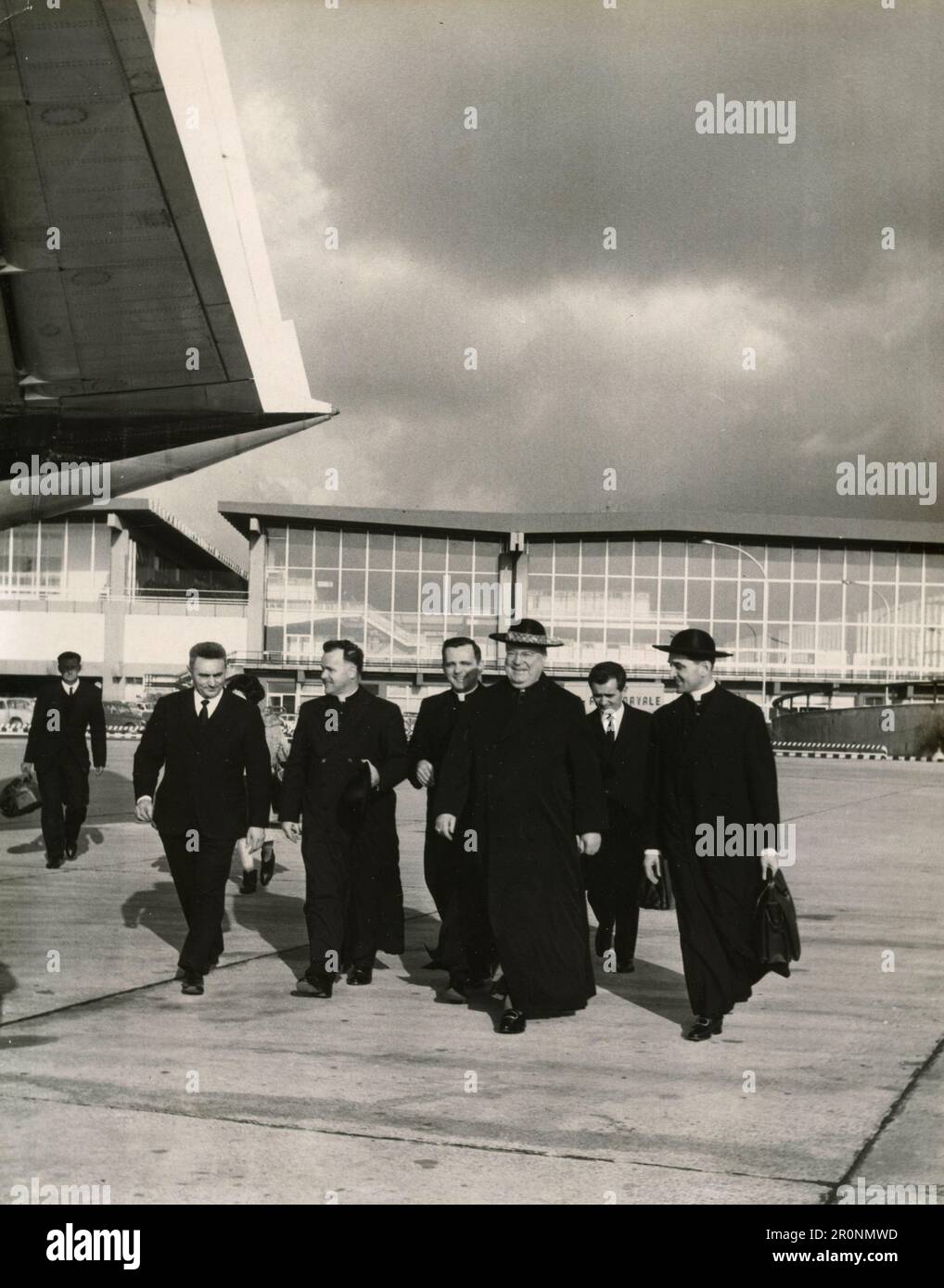 Gruppe hoher katholischer Priester auf dem Fluchtweg des Flughafens Fiumicino, Italien 1960er Stockfoto