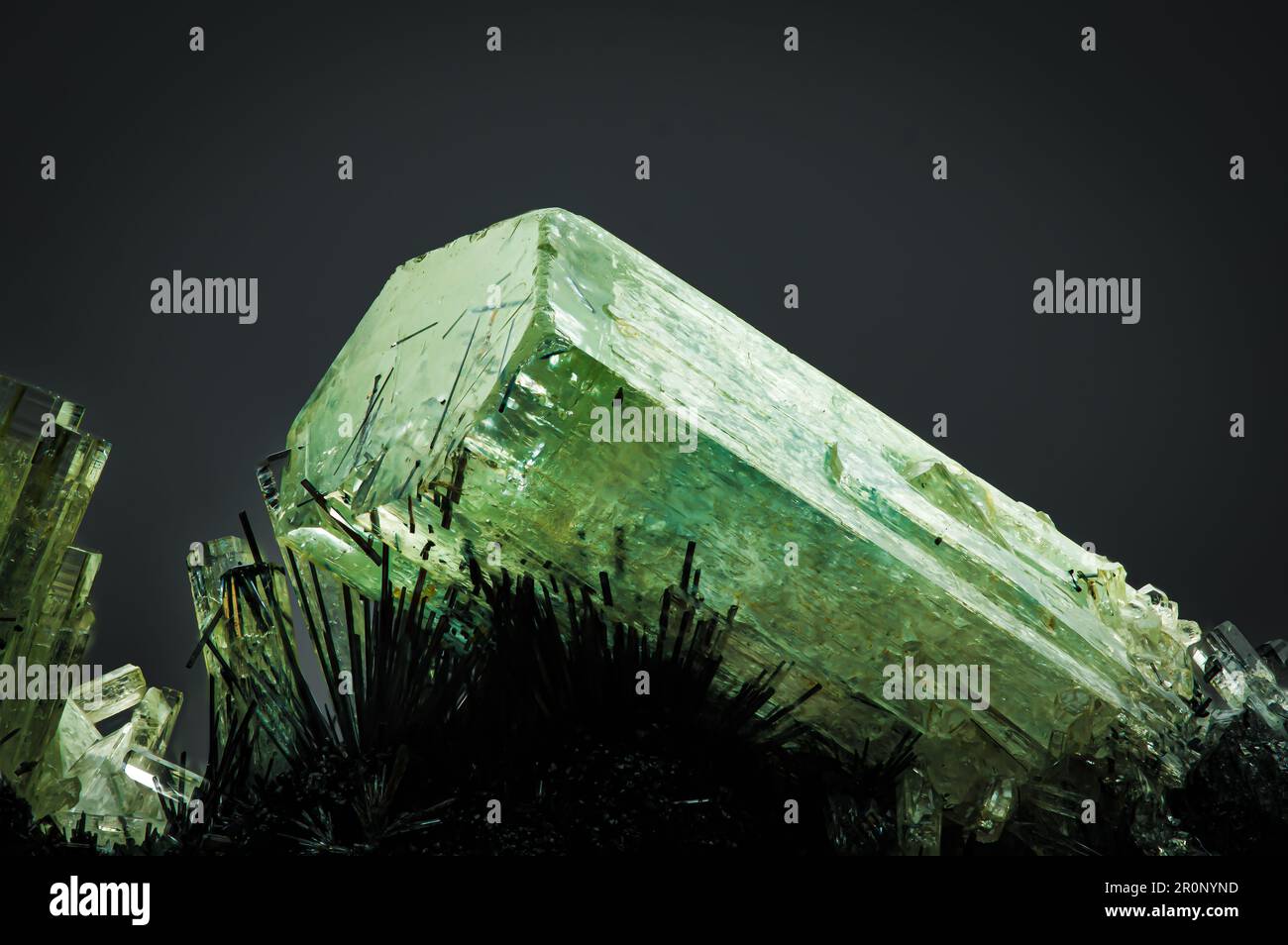 Grünes Beryl (Smaragd) auf Schorl (schwarzes Turmalin)-Matrix. Texturhintergrund für Makrodetails. Nahaufnahme von rohem, unpoliertem Halbedelstein mit Stockfoto