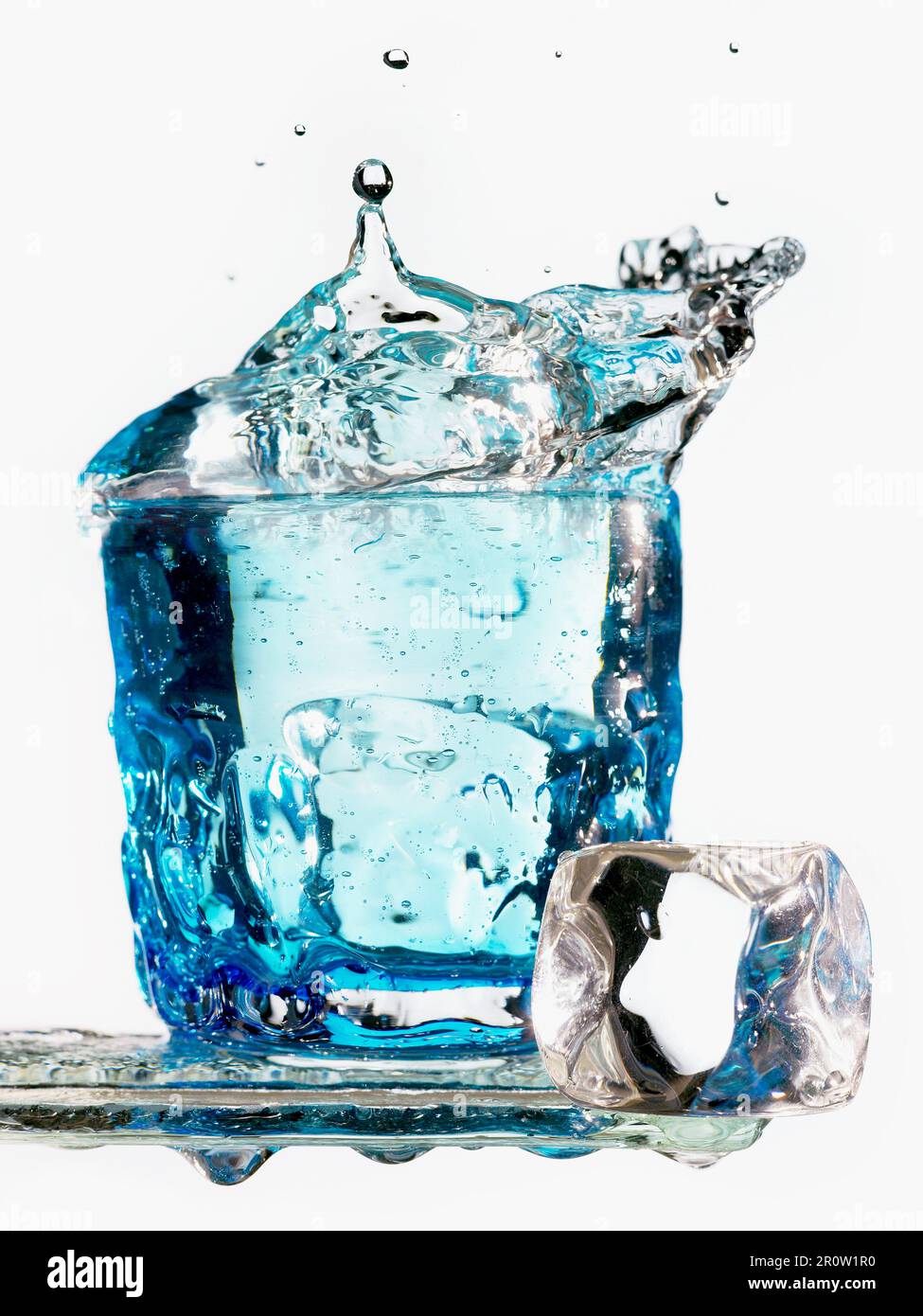 Eiswürfel in ein Glas Wasser fallen Stockfoto