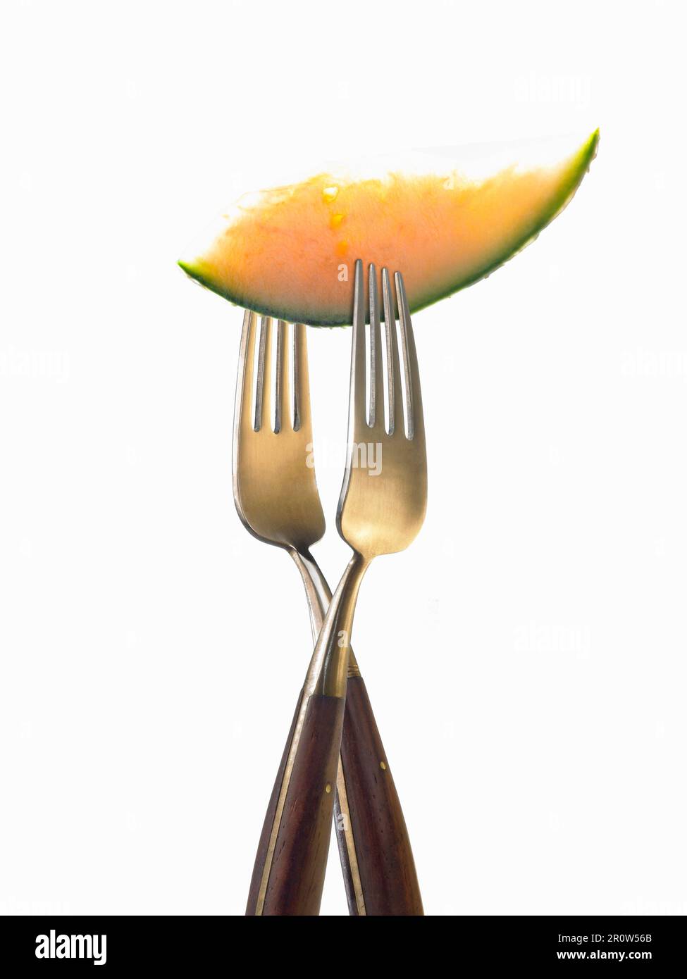 Zwei Gabeln mit einer Scheibe Melone Stockfoto