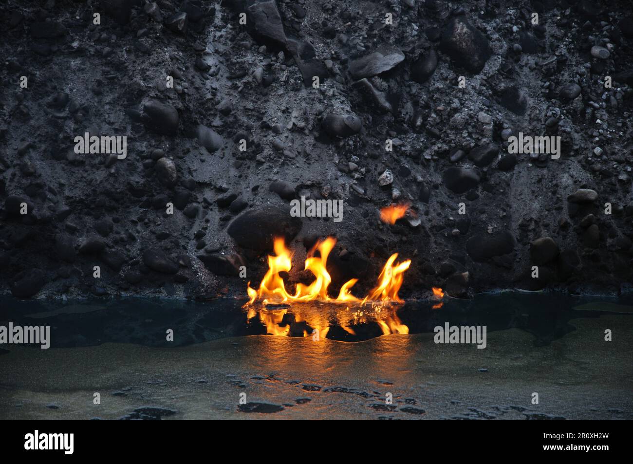 Flammen auf der Oberfläche eines öligen Teiches Stockfoto