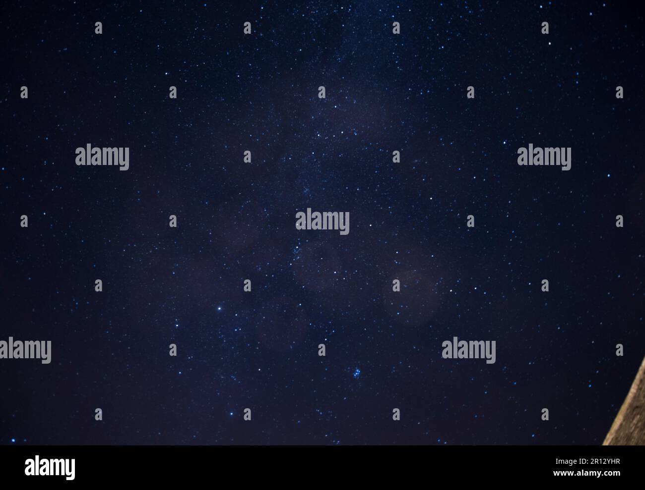 Eine dunkellila Sternennacht neben einer umgebauten Scheune Stockfoto