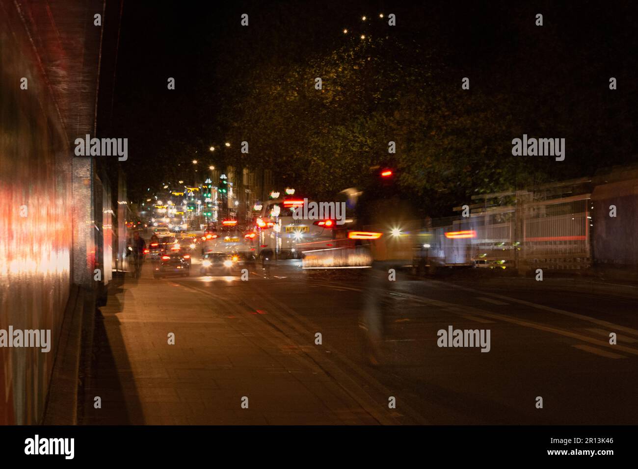 Mehrere Belichtungsfotos von Mill Road, geschäftig mit einem Fahrrad und Verkehr bei Nacht, Cambridge, Großbritannien Stockfoto