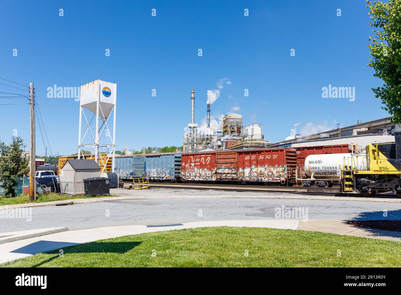 CANTON, NC, USA-4. MAI 2023: Papierfabrik Pactiv Evergreen, mit Schornsteinen, Zugwagen vor dem Hotel. Blue Ridge Süd. Stockfoto