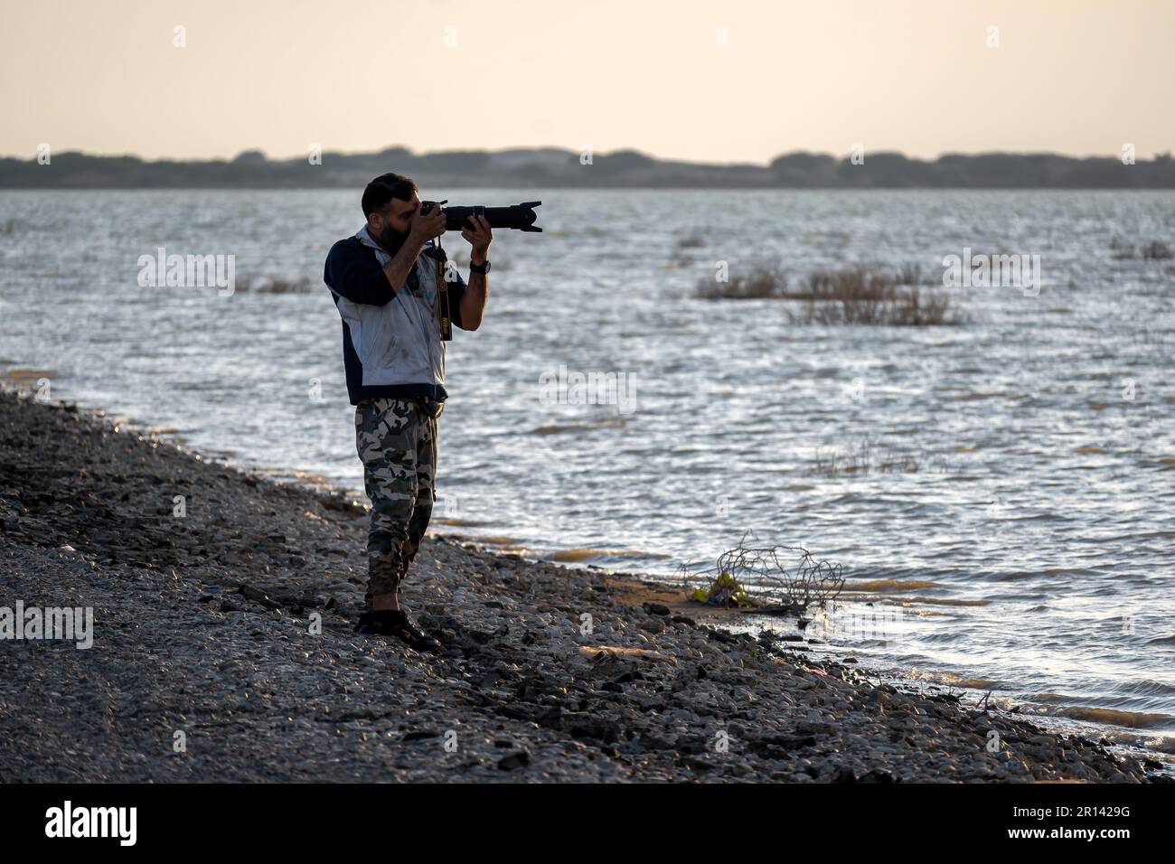 Vogelbeobachter Silhouette Fotograf am Strand Stockfoto