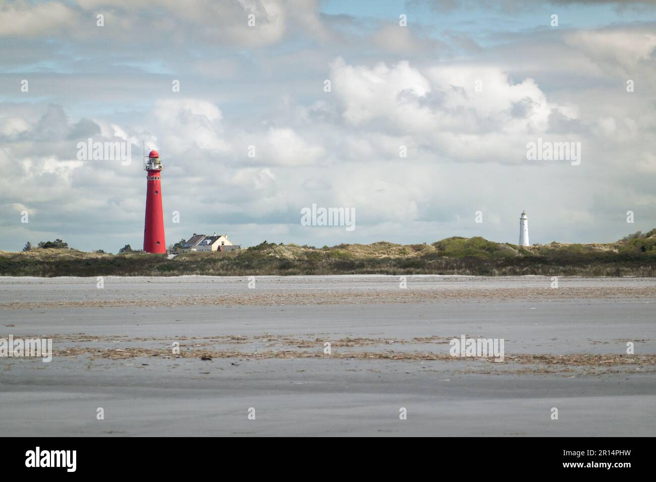 Blick auf Schlammflächen am Strand, Dünen und zwei Leuchttürme der niederländischen Insel Schiermonnikoog Stockfoto