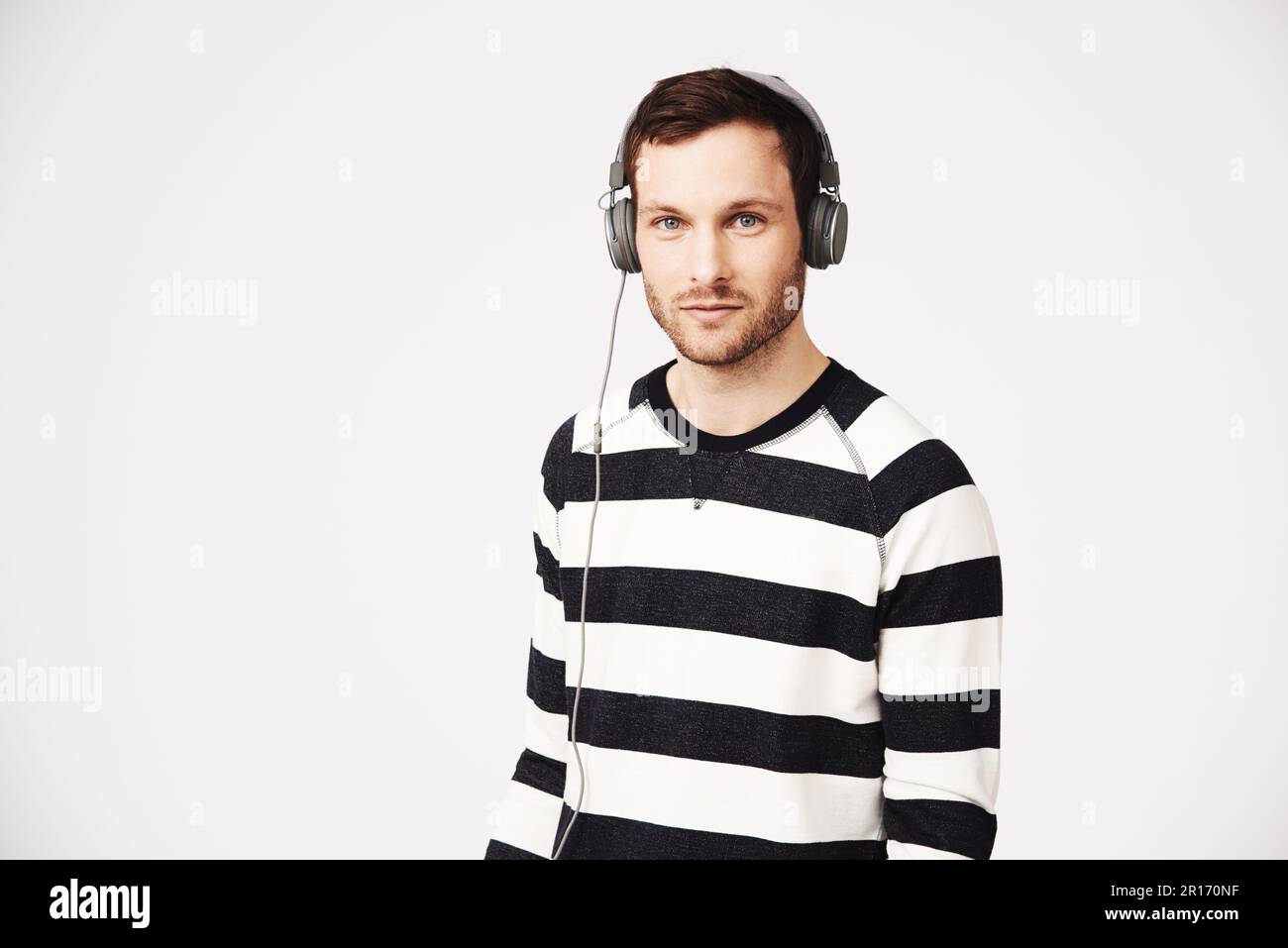 Mann, Musikporträt und Kopfhörer mit Podcast mit Relax Listening und Mockup. Isolierter, weißer Hintergrund und männliche Person, die Audio und Online hört Stockfoto