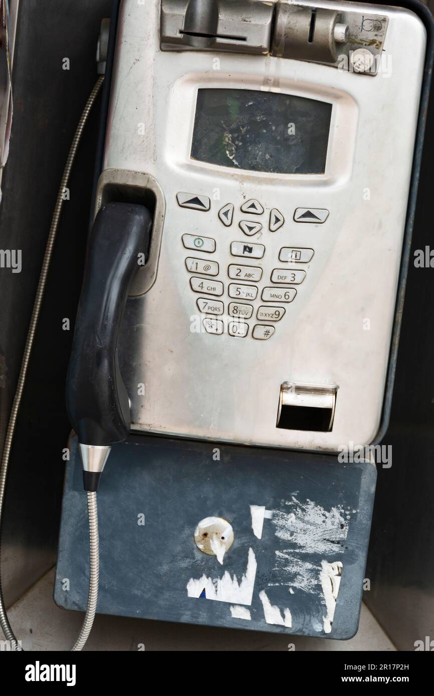 Altes, nicht benutztes, münzbetriebenes Straßentelefon aus einer Telefonzelle Stockfoto