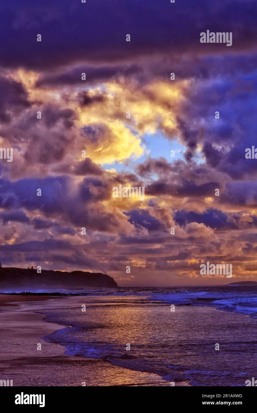 Stürmisches Wetter bei Sonnenaufgang am Caves Beach an der Pazifikküste Australiens - malerische Meereslandschaft. Stockfoto