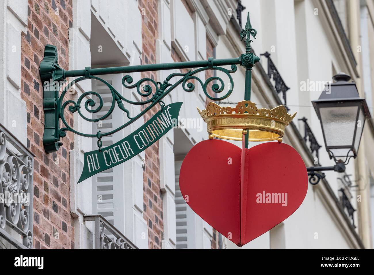 Pariser Ladenschild, das an einem historischen Gebäude angebracht ist, und ein markantes Detail in einer klassischen französischen Straßenszene bildet. Stockfoto