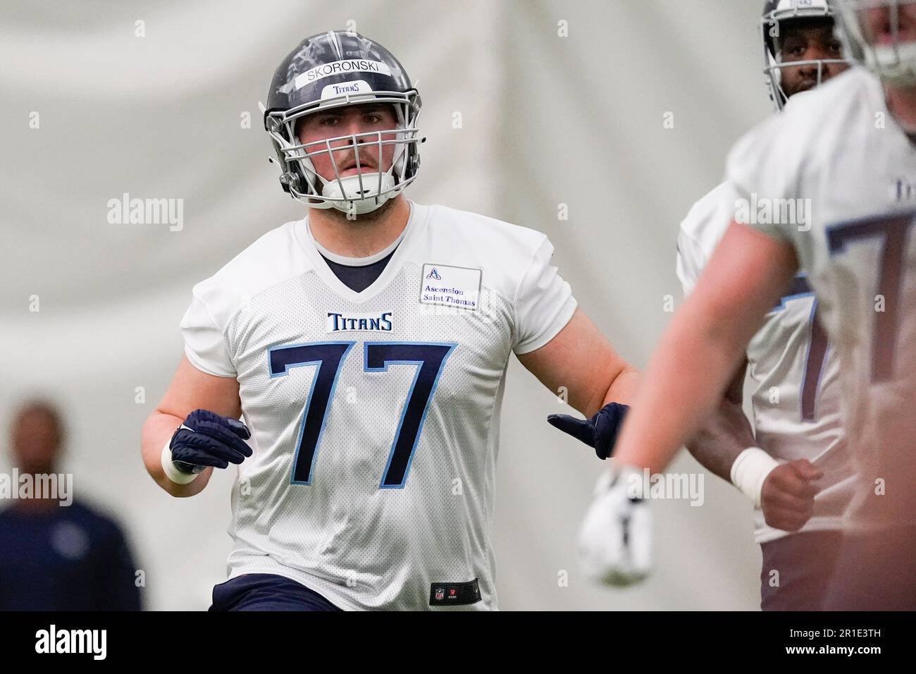 Tennessee Titans offensive lineman Peter Skoronski (77) runs through