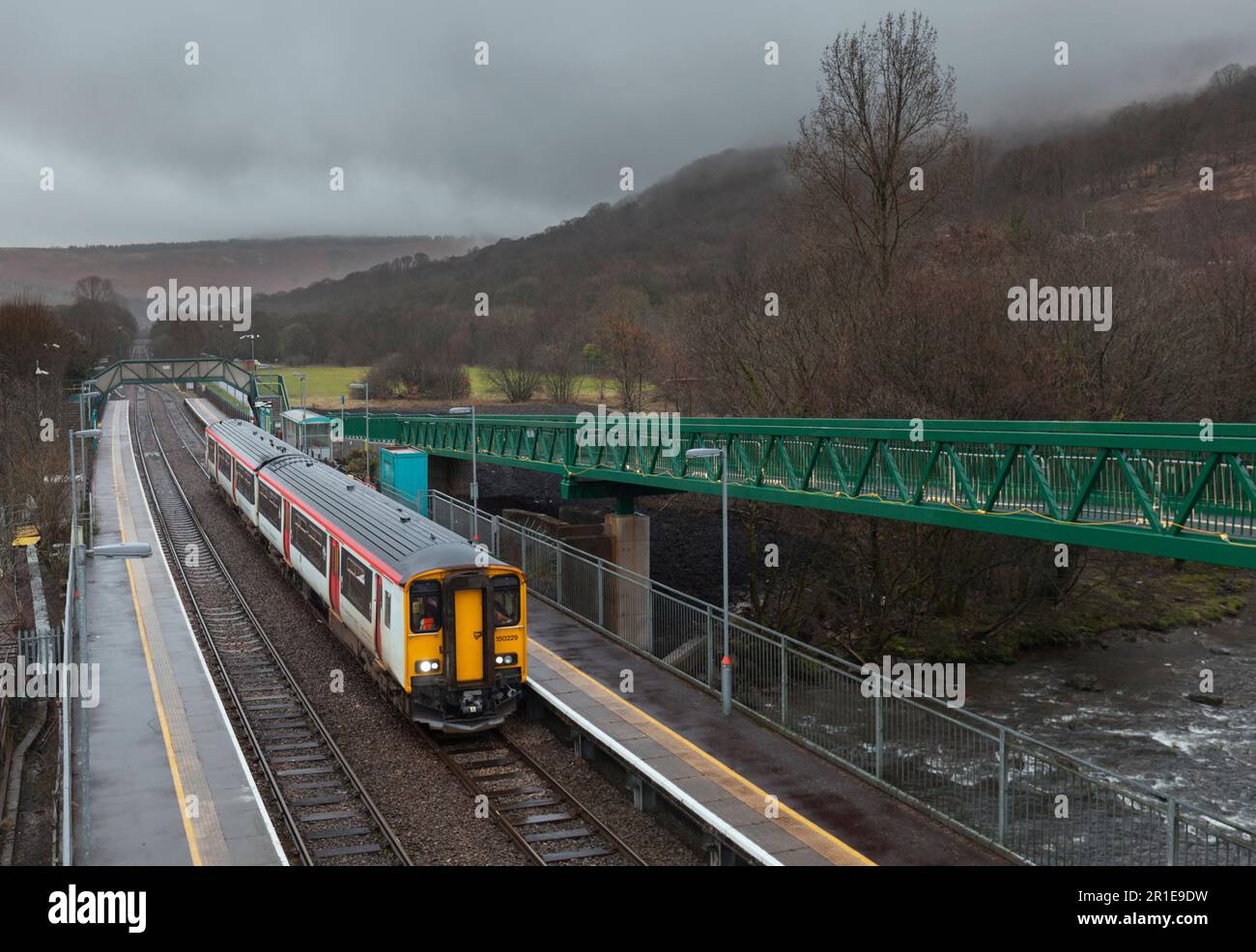 Transport für Wales Klasse 150 Sprinterzug 150229 am Bahnhof Ystrad Rhondda an einem langweiligen, nassen Tag im Regen Stockfoto