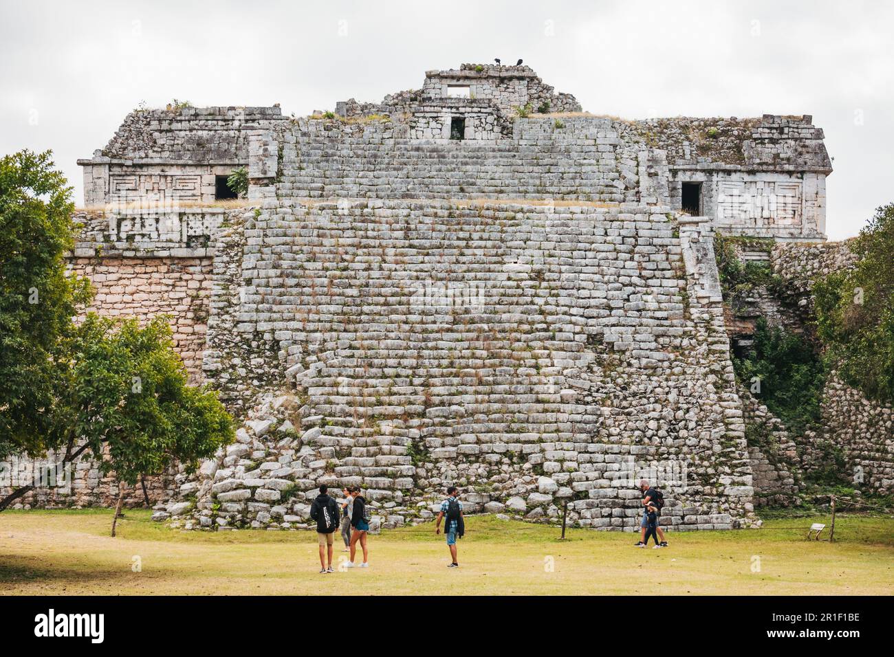 Besucher stehen vor einer großen Steintreppe zum Nonnenkloster in Chichén Itzá, Mexiko, einer der wichtigsten archäologischen Stätten der Maya Stockfoto