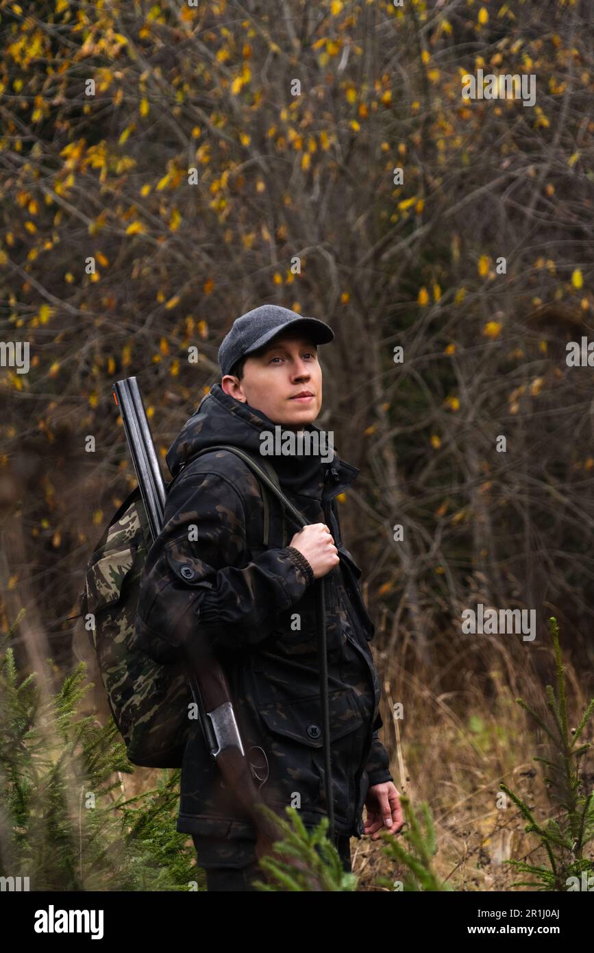 Jäger mit einer Waffe und einem Rucksack im Wald. Hochwertiges Foto Stockfoto