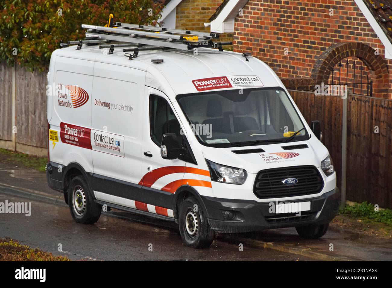 Ford Transit van UK Power Networks liefert Ihre Elektrizität und zeigt Kontaktinformationen zu Nutzfahrzeugen an, die in einer Wohnstraße geparkt sind Stockfoto