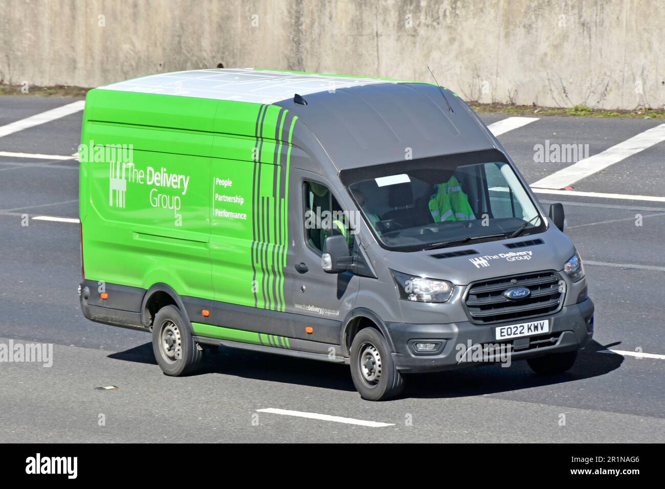 Fahrer des Transitwagens Grey Green Ford, der von der Delivery Group betrieben wird, einem Spezialunternehmen für Postzustelldienste auf der Autobahn M25 UK Stockfoto