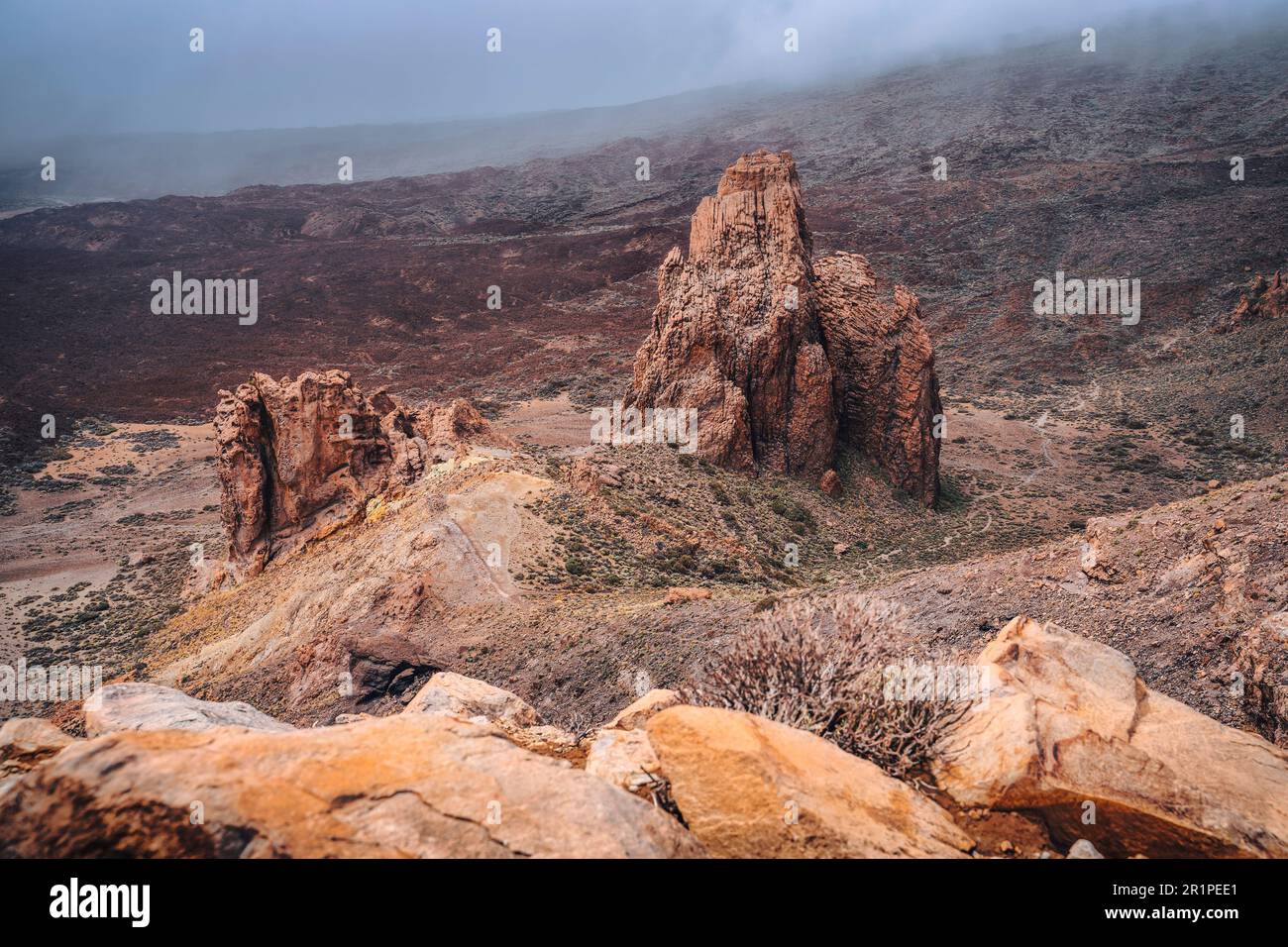 Naturlandschaft mit Blick auf die trockene Wüste und die zerklüfteten vulkanischen Berge. Farbenfroher, nebiger Himmel bei Sonnenaufgang. Gehärtete Lava, verwüstetes Tal. Teneriffa. Teide-Nationalpark. Kanarische Inseln, Spanien. Detailliertes, hochwertiges Bild. Stockfoto