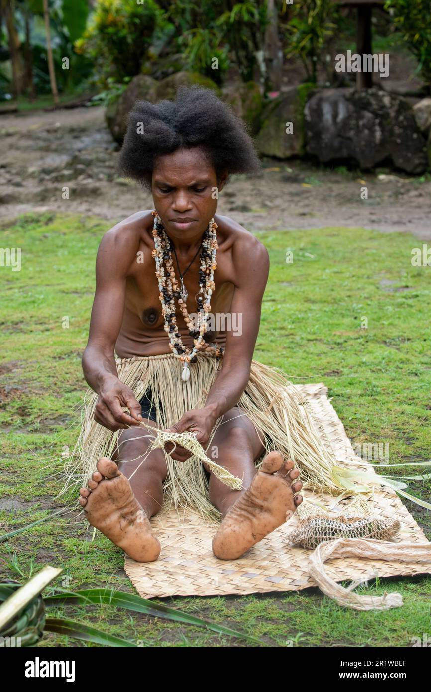 Papua-Neuguinea, Provinz Oro, Insel Tufi, Dorf Baga. Eine Frau, die Stroh webt. Stockfoto
