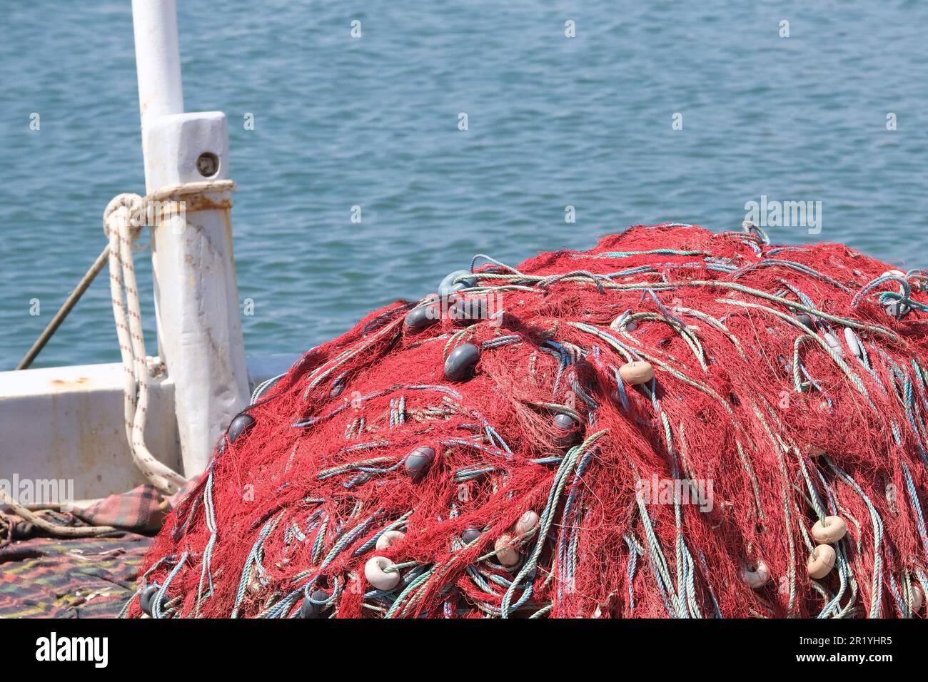 Mischung aus bunten Fischernetzen, Schwimmern und Seilen mit isoliertem Hintergrund von Schleppnetzbooten. Hintergrund des Fischers. Offener Raum. Stockfoto