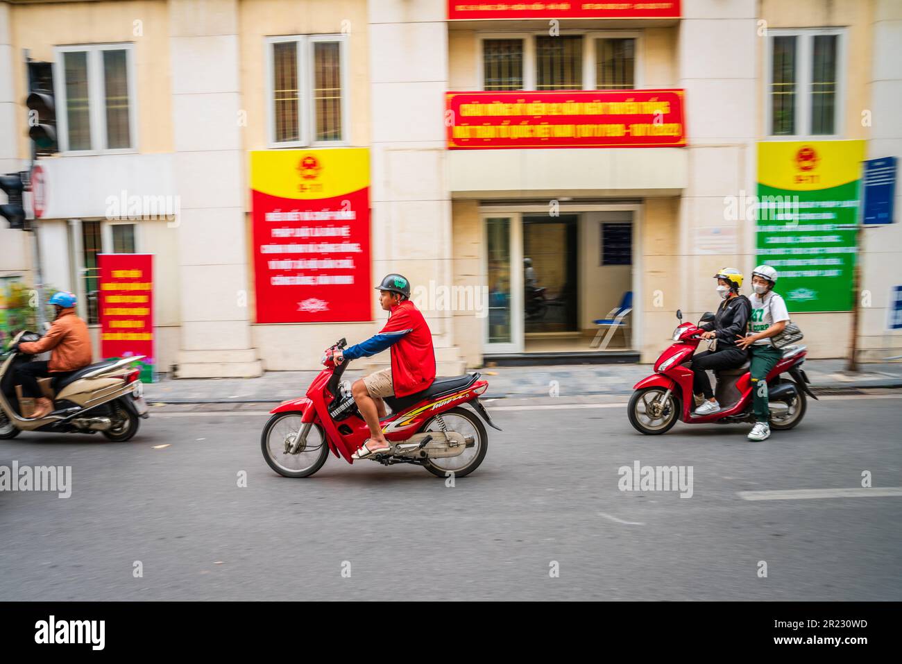 Hanoi, Vietnam, 15. November 2022: Motorroller passieren ein Partybüro im French Quarter von Hanoi Stockfoto