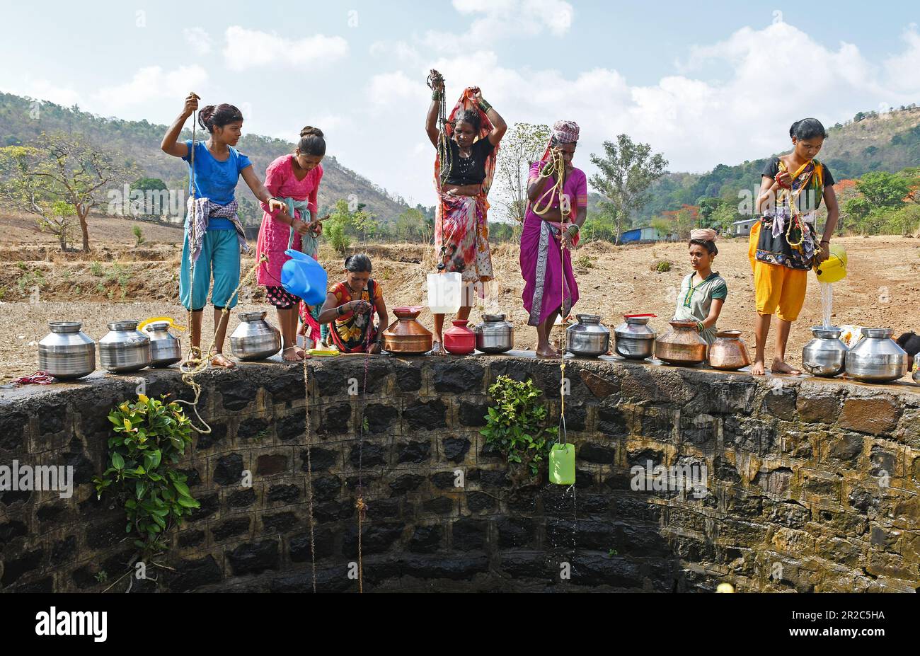 Mumbai, Indien. 16. Mai 2023. Die Dorfbewohner an der Grenzmauer ziehen Wasser aus dem Brunnen im Dorf Telamwadi in der Nähe von Vihigaon, Shahapur taluka des Bezirks Thane in der Nähe von Mumbai. Die Dorfbewohner sind während der Sommermonate mit akuter Wasserknappheit konfrontiert, da sie durch einen Wassertransporter, der nur einmal am Tag Wasser in den Brunnen entlädt, Wasser erhalten, was für sie und ihre Rinder für den täglichen Gebrauch nicht ausreicht. (Foto: Ashish Vaishnav/SOPA Images/Sipa USA) Guthaben: SIPA USA/Alamy Live News Stockfoto