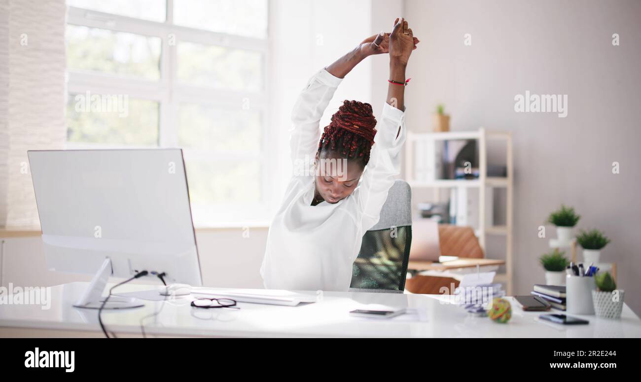 Frau, Die Sich Im Bürostuhl An Der Rezeption Entspannt Stockfoto