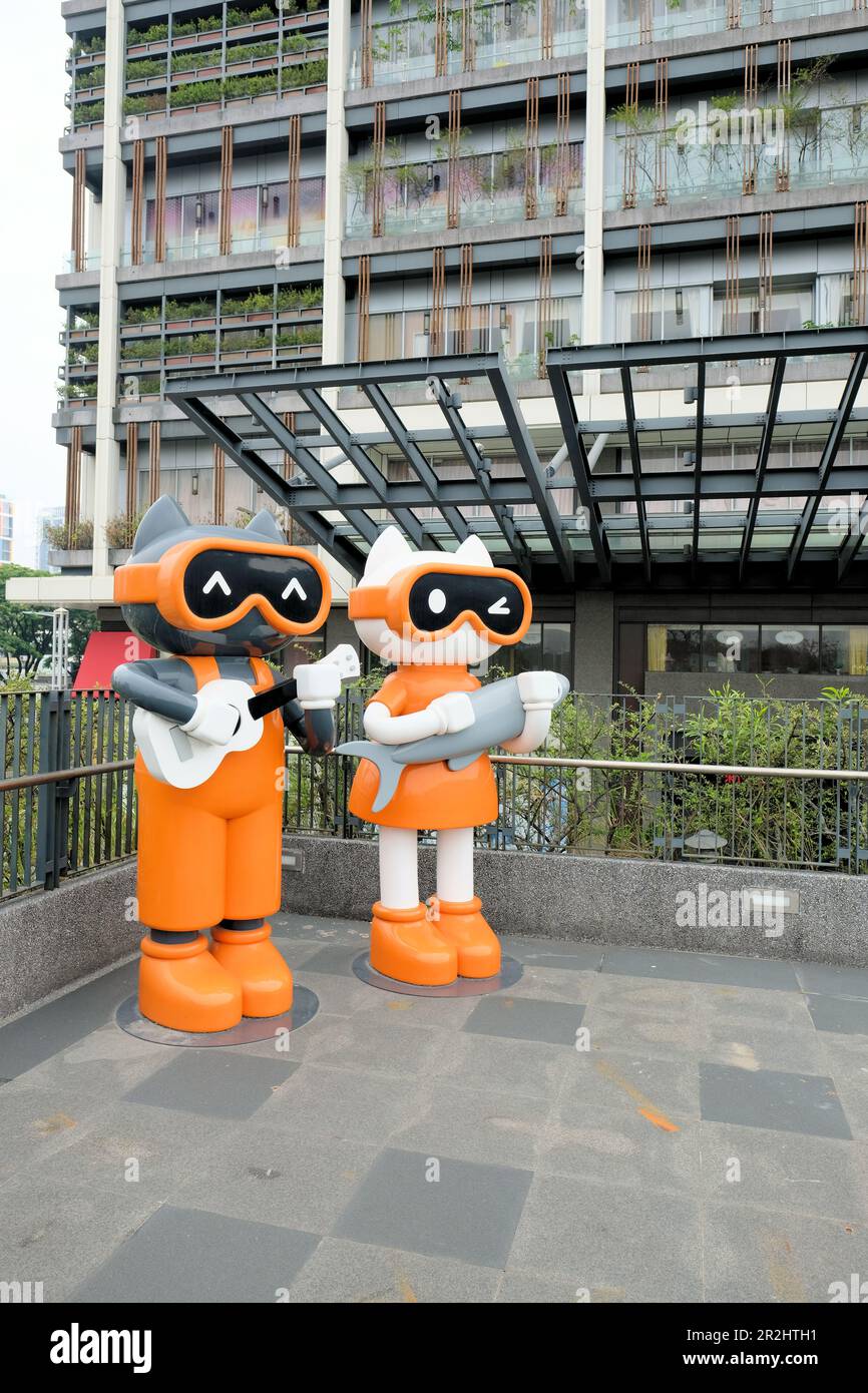 Lebensgroße Katzenstatuen im Xingfu Park oder Happiness Park in Kaohsiung, Zuoying District, Taiwan; niedliche Cartoon-Katzen, die Gitarre und Fisch spielen. Stockfoto
