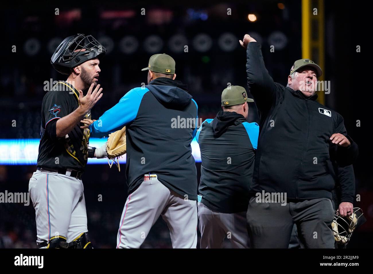 Miami Marlins catcher Jacob Stallings, left, reacts while being ejected