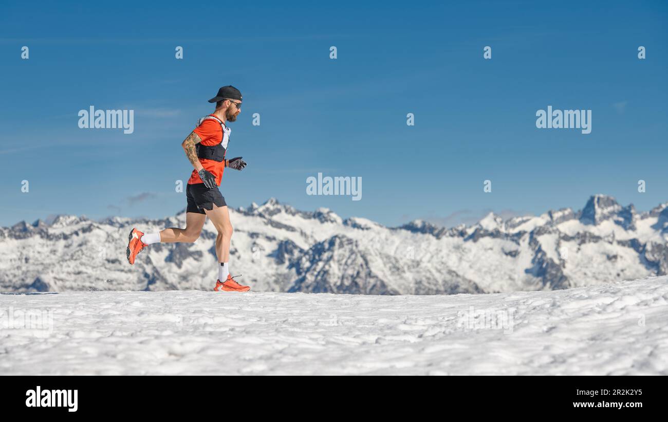 Ein Bergläufer trainiert im Schnee in großer Höhe Stockfoto